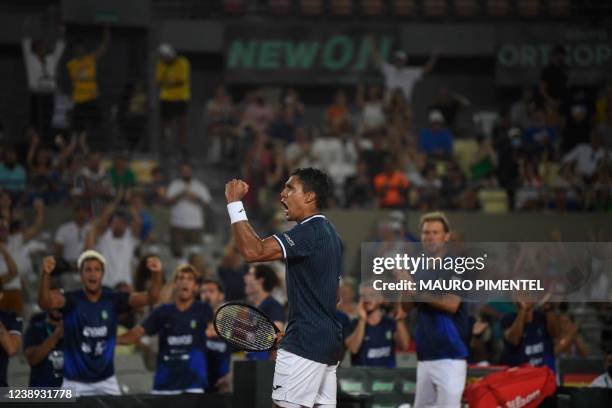 Brazilian tennis player Thiago Monteiro celebrates after scoring a point against German tennis player Jan-Lennard Struff during a Davis Cup match at...