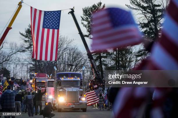 Supporters cheer as they greet the Peoples Convoy of truckers as it arrives at the Hagerstown Speedway on March 4, 2022 in Hagerstown, Maryland. The...