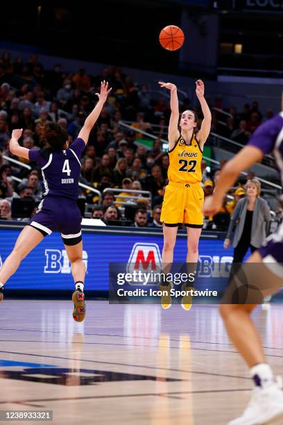 Iowa Hawkeyes guard Caitlin Clark fires up the jump shot over Northwestern Wildcats guard Jillian Brown during the Women's Big Ten Tournament game...