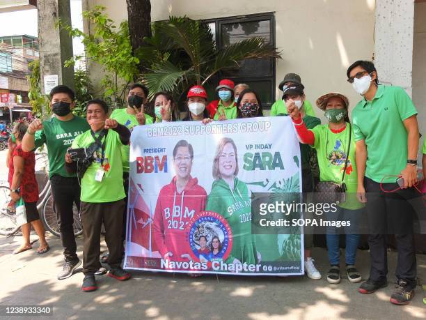 Supporters hold a campaign banner for Ferdinand "Bongbong" Marcos Jr. And Sara Duterte-Carpio. Presidential daughter and Davao City Mayor Sara...