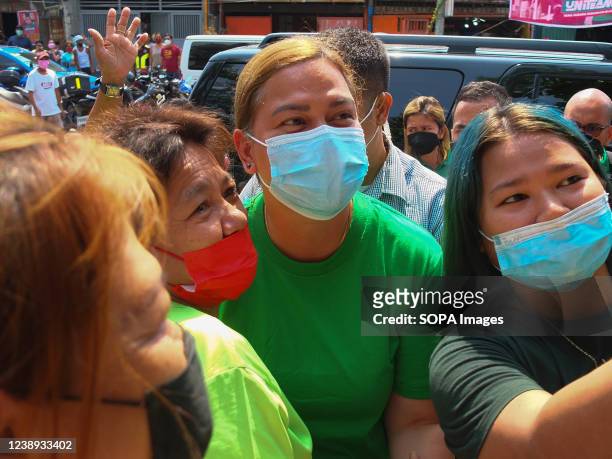 Mayor Sara Duterte-Carpio posed for a picture with her supporters during the event . Presidential daughter and Davao City Mayor Sara Duterte-Carpio...