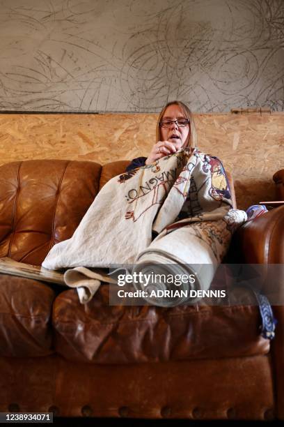 Mia Hansson sits on the couch at home while she works on her embroidery replica of The Bayeux Tapestry in Wisbech, east of England on February 24,...