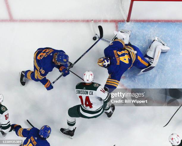 Craig Anderson of the Buffalo Sabres looks to cover the puck up against Joel Eriksson Ek of the Minnesota Wild during an NHL game on March 4, 2022 at...
