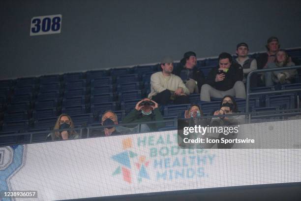 Fan sitting in the upper deck uses binoculars to watch a college basketball game between the Saint Louis Billikens and Rhode Island Rams on March 2...