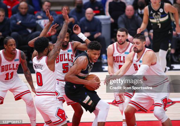 Milwaukee Bucks forward Giannis Antetokounmpo tripled teamed by Chicago Bulls guard Coby White Chicago Bulls forward Derrick Jones Jr. And Chicago...