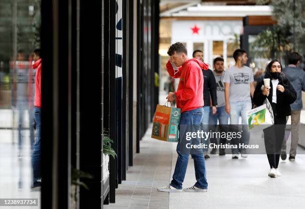 Shoppers at Westfield Century City in Los Angeles on Friday, March 4, 2022. Los Angeles County ends indoor mask mandates today.