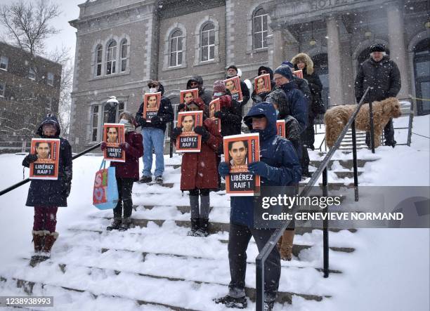 This photo taken on February 24, 2022 shows people taking part in the 374th vigil organized to demand the release of Raif Badawi in Sherbrooke,...