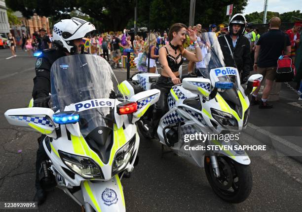 Police allow a member of the Dykes on Bikes to mount a police motorcycle ahead of the 44th Sydney Gay and Lesbian Mardi Gras Parade at the Sydney...