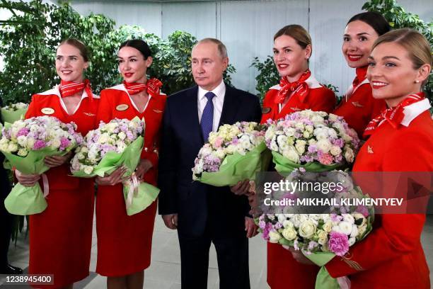 Russian President Vladimir Putin poses for photo with Aeroflot employees during his visit to Aeroflot aviation training complex outside Moscow on...