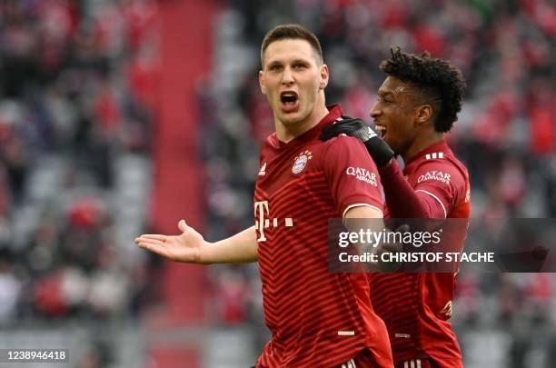 Bayern Munich's German defender Niklas Suele celebrates scoring the opening goal with his teammate Bayern Munich's French forward Kingsley Coman...