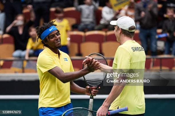 Sweden's Elias Ymer and Andre Goransson celebrate their victory after the tennis double qualifier for the playoffs in the Davis Cup between Sweden...