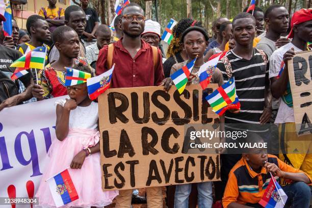 Holding placards with pro russian slogans, demonstrators gather in Bangui on March 5, 2022 during a rally in support of Russia. - A hundred people...