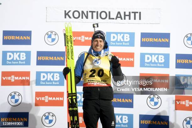 Winner Quentin Fillon Maillet of France celebrates on the podium after the men's 10 km sprint competition of the IBU World Cup Biathlon event in...