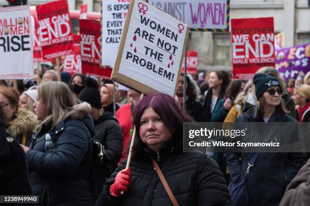 Women hold placards as they take part in Million Women Rise march through central London to New Scotland Yard in a protest demanding an end to male...