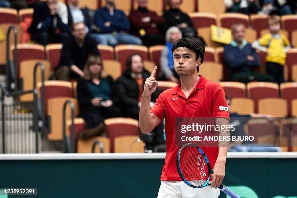 Japan's Taro Daniel gestures during the single tennis match against Sweden's Dragos Madaras in the qualifier for the playoffs of the Davis Cup...