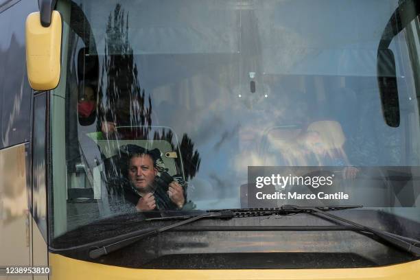 Ukrainian smiles from a bus, loaded with Ukrainian refugees fleeing the war after the Russian invasion, arriving at the Garibaldi barracks in...