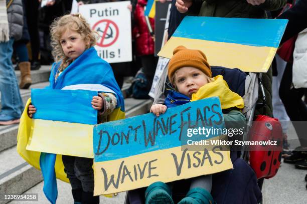 Young children hold placards as Ukrainian people and their supporters demonstrate in Trafalgar Square calling on the British government to support...