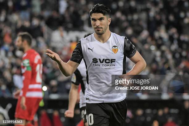 Valencia's Spanish midfielder Carlos Soler celebrates after scoring his team's third goal during the Spanish league football match between Valencia...