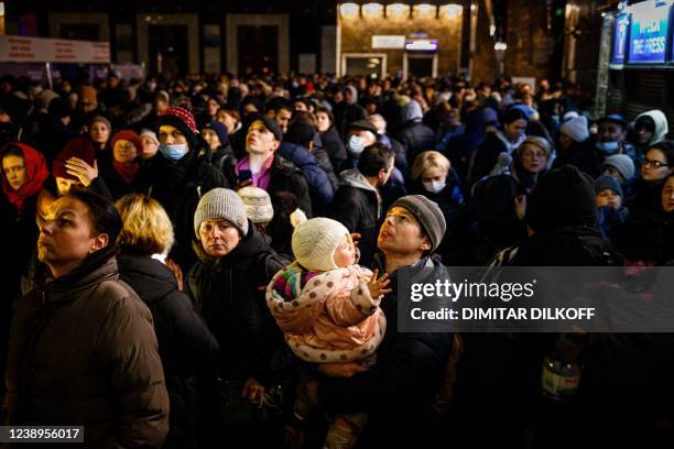 People wait to board an evacuation train at Kyiv central train station on March 5, 2022. - The UN Human Rights Council on March 4 overwhelmingly...