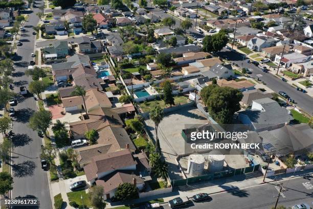 Oil production equipment is seen among homes in the Wilmington neighborhood of Los Angeles, California, on February 24, 2022. From rural areas of the...