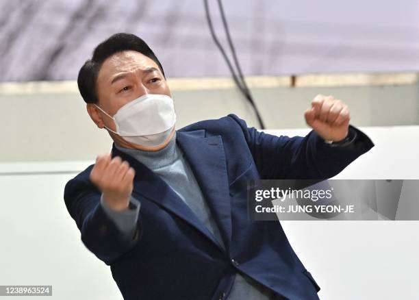 This picture taken on March 5, 2022 shows South Korea's presidential candidate Yoon Suk-yeol of the main opposition People Power Party gesturing to...