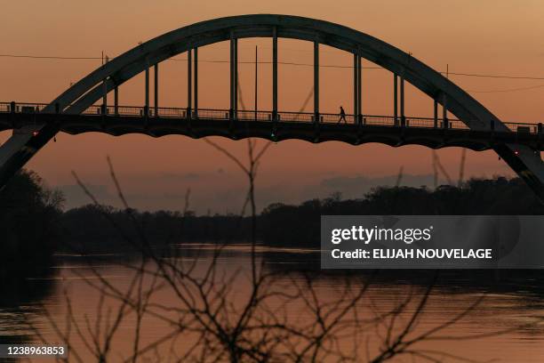 Man walks across the Edmund Pettus Bridge days before the 57th anniversary of 'Bloody Sunday', in Selma, Alabama on March 5, 2022. - On "Bloody...