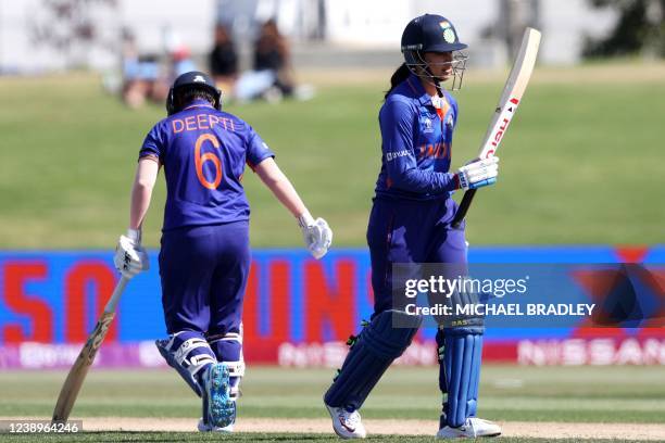 India's Smriti Mandhana celebrates reaching her half century during Round 1 Women's Cricket World Cup match between India and Pakistan at Bay Oval in...