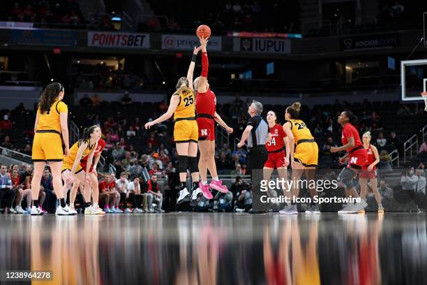 Iowa forward Monika Czinano and Nebraska center Alexis Markowski jump for the opening tip during a Big Ten Tournament college basketball game between...