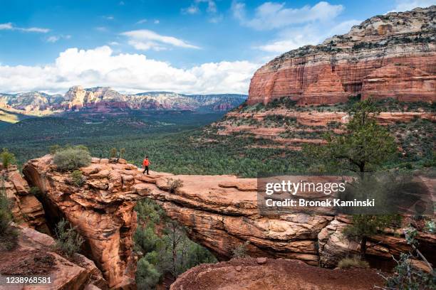 a man walks across devil's bridge, sedona - sightseeing in sedona stock pictures, royalty-free photos & images