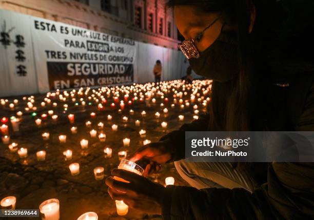 Journalist lights a candle at a candlelight vigil seen at the March 31 Square following the national meeting of journalists against violence against...