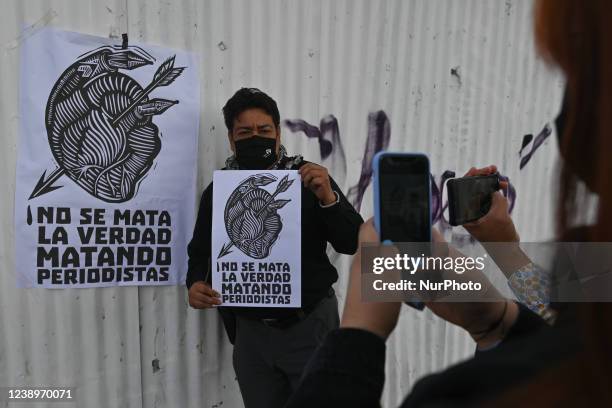 Journalist holds a placard with words 'The truth is not killed by killing journalists' at Cathedral Square after leaving the national meeting of...