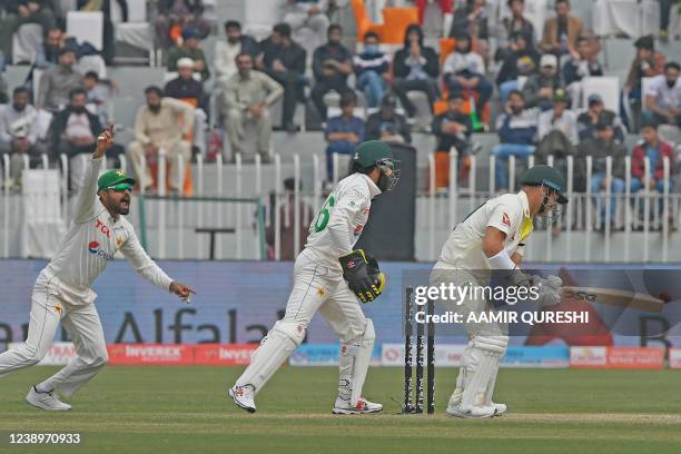 Australia's David Warner is bowled out by Pakistan's Sajid Khan as Pakistan's captain Babar Azam and teammate wicketkeeper Mohammad Rizwan celebrate...