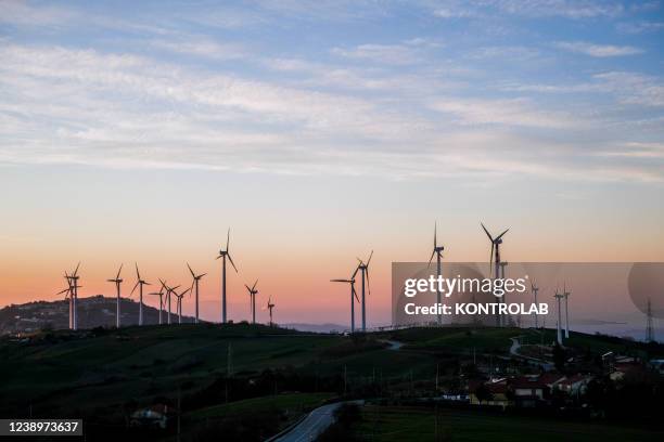 View at sunset of Parco Eolico Iardino wind power plant.