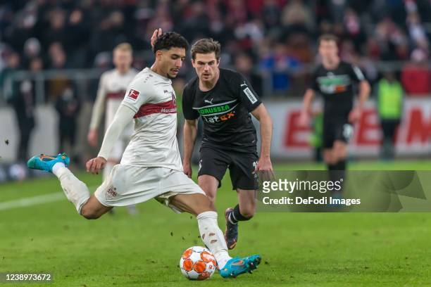 Omar Khaled Mohamed Marmoush of VfB Stuttgart and Jonas Hofmann of Borussia Moenchengladbach battle for the ball during the Bundesliga match between...