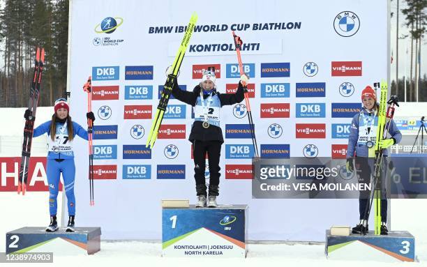 Second placed Dorothea Wierer of Italy, winner Tiril Eckhoff of Norway and third placed Denise Herrmann of Germany celebrate on the podium after the...