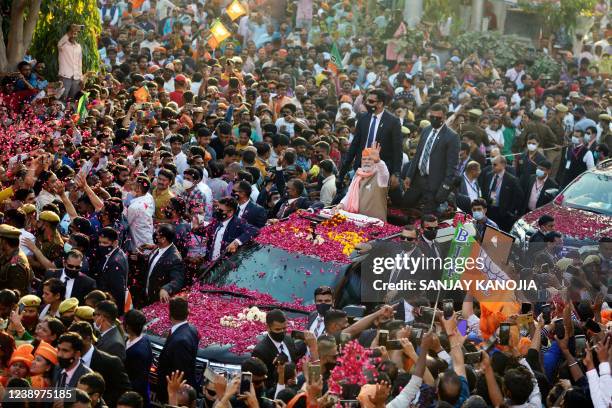 In this picture taken on March 4 India's Prime Minister Narendra Modi gestures during a road show ahead of seventh phase of the Uttar Pradesh state...