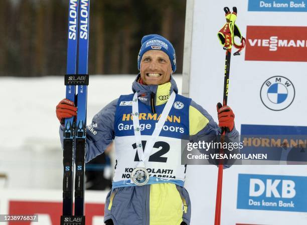 Second placed Erik Lesser of Germany celebrates on the podium of the Men's Pursuit 12,5km competition of the IBU World Cup Biathlon event in...