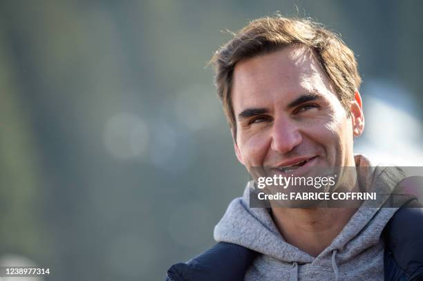 Former men's tennis world number one Swiss Roger Federer speaks at the arrival area of the Women's giant slalom event at the FIS Alpine Ski World Cup...