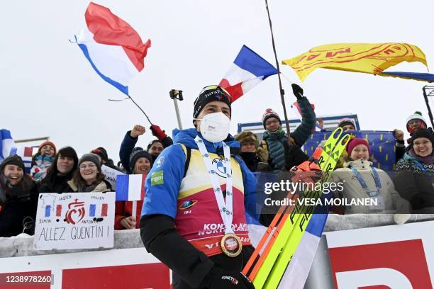 Winner Quentin Fillon Maillet of France celebrates with fans after the Men's Pursuit 12,5km competition of the IBU World Cup Biathlon event in...