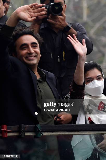 Chairman of the Pakistan Peoples Party Bilawal Bhutto Zardari waves next to his sister Asifa Bhutto Zardari during an anti-government march on his...