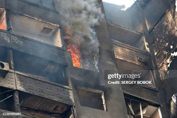 Building burns after Russian troops shelled the area in the second largest Ukrainian city of Kharkiv, in the east on March 6, 2022. - On the eleventh...