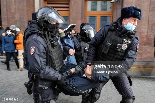 Russian Police officers detain a man during an unsanctioned protest rally against the military invasion in Ukraine on March 6, 2022 in Moscow,...