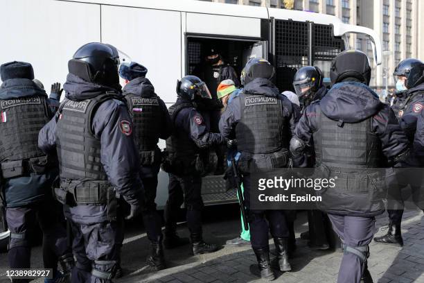 Russian Police officers detain a man during an unsanctioned protest rally against the military invasion in Ukraine on March 6, 2022 in Moscow,...