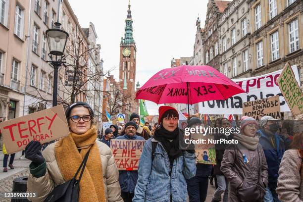 Protesters with feminist, pro-choice banners and anti Russia against Ukraine war banners are seen in Gdansk, Poland on 6 March 2022 The Manifa is...