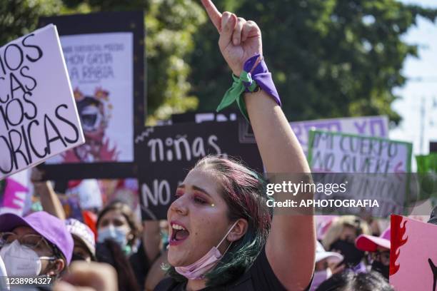 Woman gestures while marching during a demonstration on International Women's Month on March 6, 2022 in San Salvador, El Salvador.