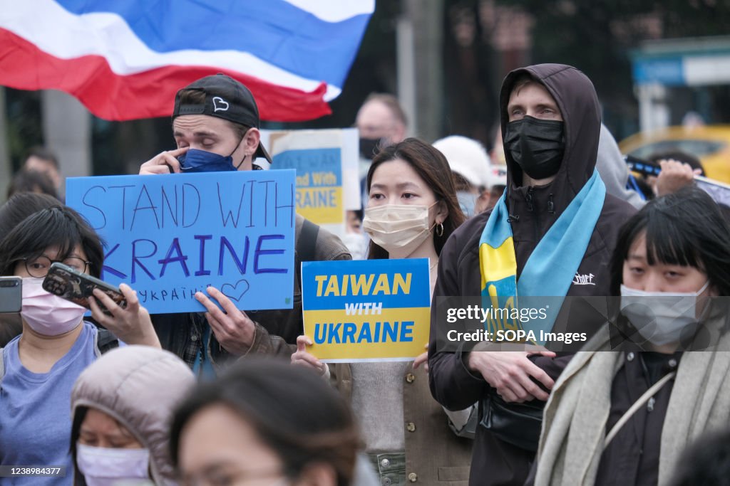 Protesters hold signs expressing their opinion during a...