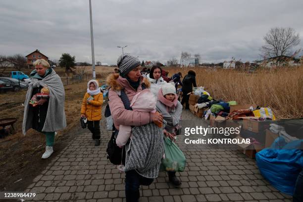 Ukrainian refugees enter Poland at the Medyca border crossing, fleeing the war unleashed by Russia which hits their territories with bombings and...