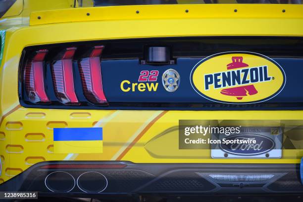 Ukrainian flag is placed on the bumper of the car of Joey Logano in support of Ukraine from the invasion of Russia in the Neon Garage prior to the...