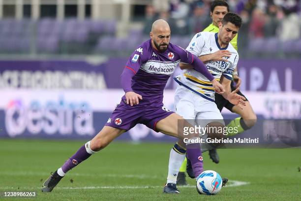 Riccardo Saponara of ACF Fiorentina in action against Davide Faroni of Hellas Verona during the Serie A match between ACF Fiorentina and Hellas...