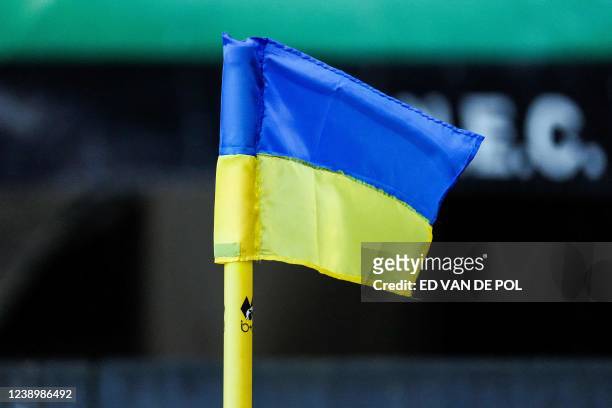 This photograph taken on March 6, 2022 shows a corner flag in the colours of the Ukrainian national flag during the Dutch Eredivisie match between...